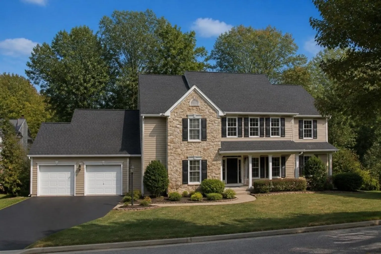 A two-story colonial home with a new architectural shingle roof