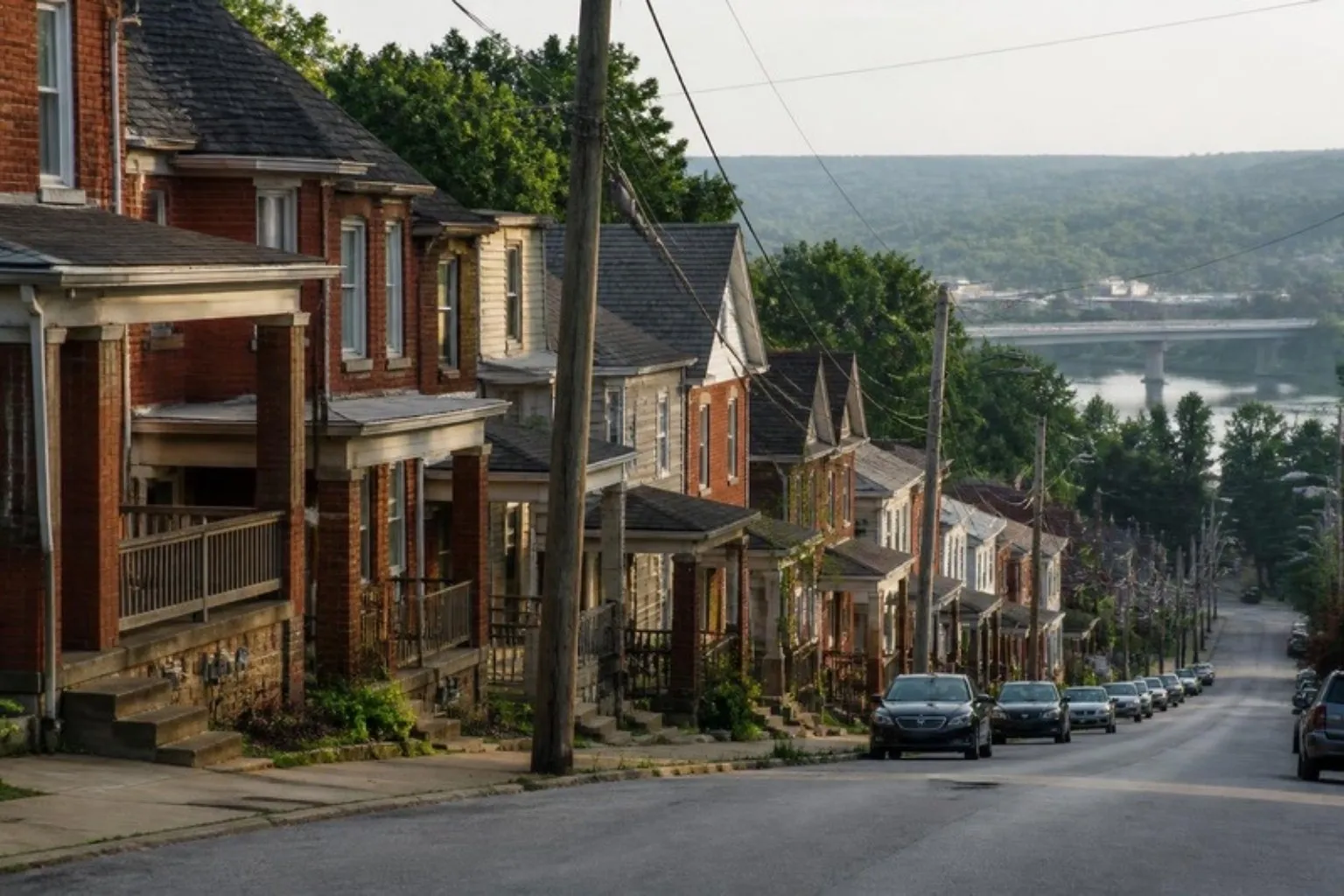 Brick rowhomes and twins on a hillside street
